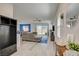 Bright living room with wood floors leading to the dining and sliding glass doors at 8898 Sasquatch Run Ave, Las Vegas, NV 89166