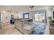 Open concept living room with wood floors, connected to the kitchen and dining area at 8898 Sasquatch Run Ave, Las Vegas, NV 89166