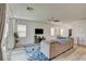 Bright living room featuring a plush sofa, modern entertainment center, and sliding glass doors at 8898 Sasquatch Run Ave, Las Vegas, NV 89166