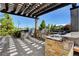 Well-equipped outdoor kitchen with stainless steel appliances, stone accents, and a sleek countertop at 8898 Sasquatch Run Ave, Las Vegas, NV 89166
