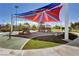 Vibrant community playground featuring play structures and a colorful shade canopy, perfect for outdoor fun at 8898 Sasquatch Run Ave, Las Vegas, NV 89166