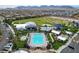 An aerial view of the community pool featuring a large swimming area, lounge chairs, and landscaping at 8898 Sasquatch Run Ave, Las Vegas, NV 89166