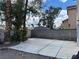 Large concrete patio with gravel landscaping, and tall privacy fence and trees at 9004 Dulcimer Ln, Las Vegas, NV 89123