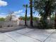 Wide concrete patio with block wall, and mature trees at 9004 Dulcimer Ln, Las Vegas, NV 89123