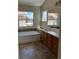 Bathroom with a soaking tub, ceramic tile flooring, and a double sink vanity with storage at 9004 Dulcimer Ln, Las Vegas, NV 89123