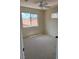 A carpeted bedroom featuring natural light and a ceiling fan at 9004 Dulcimer Ln, Las Vegas, NV 89123