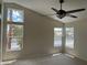 Bright bedroom with a ceiling fan and three windows letting in natural light at 9004 Dulcimer Ln, Las Vegas, NV 89123