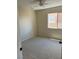This cozy bedroom has neutral carpeting, a ceiling fan, and a window that brings in natural light at 9004 Dulcimer Ln, Las Vegas, NV 89123