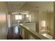 Upstairs hallway with beautiful hardwood floors, a hanging light fixture and views of the living room at 9004 Dulcimer Ln, Las Vegas, NV 89123