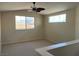 Cozy upstairs loft with a ceiling fan and two large windows offering natural light at 9004 Dulcimer Ln, Las Vegas, NV 89123