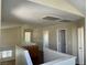 Upstairs hallway with views to the downstairs and access to multiple bedrooms at 9004 Dulcimer Ln, Las Vegas, NV 89123