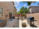 Cozy back patio features a gas grill, patio furniture, and privacy walls, perfect for outdoor dining and entertaining at 9218 Grassy Weep Ct, Las Vegas, NV 89178
