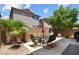 This backyard oasis offers a patio with a table set under a clear blue sky at 9218 Grassy Weep Ct, Las Vegas, NV 89178
