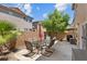 This backyard oasis offers a patio with a table set under a clear blue sky at 9218 Grassy Weep Ct, Las Vegas, NV 89178