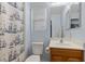 Cozy bathroom with a nautical-themed shower curtain and a wooden vanity at 9218 Grassy Weep Ct, Las Vegas, NV 89178