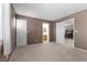 A spacious bedroom with a view of the ensuite bathroom showcasing two entry doors at 9218 Grassy Weep Ct, Las Vegas, NV 89178