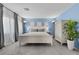 Primary bedroom featuring blue walls, carpet and a white paneled bed at 9218 Grassy Weep Ct, Las Vegas, NV 89178