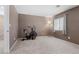 Bright bedroom with neutral carpet, large window, and an exercise bike at 9218 Grassy Weep Ct, Las Vegas, NV 89178