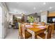 Dining and living area with bright lighting, wooden floors, and an 8-person dining table at 9218 Grassy Weep Ct, Las Vegas, NV 89178