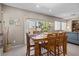 Dining area features a large wooden table, tile floors, and sliding glass door to backyard at 9218 Grassy Weep Ct, Las Vegas, NV 89178