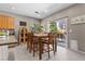 Dining area with sliding glass doors to the backyard and stylish wooden table and chairs at 9218 Grassy Weep Ct, Las Vegas, NV 89178