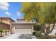 A charming two-story home with a well-maintained front yard, and a two-car garage showcasing suburban charm at 9218 Grassy Weep Ct, Las Vegas, NV 89178