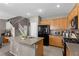 Kitchen with stainless appliances, an island with a sink, and wooden cabinets at 9218 Grassy Weep Ct, Las Vegas, NV 89178