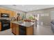 Bright kitchen boasts stainless appliances, tile floors, and an island with a sink at 9218 Grassy Weep Ct, Las Vegas, NV 89178