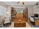 Inviting living room featuring built-in bookshelves, a ceiling fan, and comfortable seating at 9218 Grassy Weep Ct, Las Vegas, NV 89178
