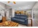 Open-concept living room with a comfortable blue couch and stylish wooden coffee table at 9218 Grassy Weep Ct, Las Vegas, NV 89178