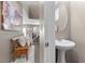 This powder room features a modern sink and is bathed in natural light from the hallway at 9218 Grassy Weep Ct, Las Vegas, NV 89178