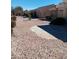 Backyard featuring low-maintenance desert landscaping, rock features, and a stone patio at 9312 Yucca Blossom Dr, Las Vegas, NV 89134