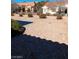 Backyard featuring low-maintenance desert landscaping, rock features, and stone patio at 9312 Yucca Blossom Dr, Las Vegas, NV 89134