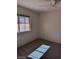 Well-lit bedroom with a ceiling fan and a large window offering neighborhood views at 9312 Yucca Blossom Dr, Las Vegas, NV 89134