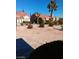 Front yard featuring low-maintenance desert landscaping, rock features, and mature palm tree at 9312 Yucca Blossom Dr, Las Vegas, NV 89134