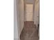 Hallway leading to bathroom with neutral walls, carpet flooring, and white doors at 9312 Yucca Blossom Dr, Las Vegas, NV 89134