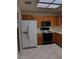A kitchen featuring wooden cabinets and a white refrigerator, equipped with modern appliances and a light-filled atmosphere at 9312 Yucca Blossom Dr, Las Vegas, NV 89134