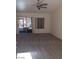 Spacious living room with new carpet, ceiling fan, and sliding door to the back patio at 9312 Yucca Blossom Dr, Las Vegas, NV 89134