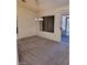 Spacious living room with new carpet, ceiling fan, and sliding door to the back patio at 9312 Yucca Blossom Dr, Las Vegas, NV 89134