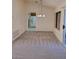 Spacious living room with new carpet, ceiling fan, and sliding door to the back patio at 9312 Yucca Blossom Dr, Las Vegas, NV 89134