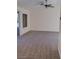Spacious living room with new carpet, ceiling fan, and sliding door to the back patio at 9312 Yucca Blossom Dr, Las Vegas, NV 89134