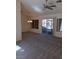 Spacious living room with new carpet, ceiling fan, and sliding door to the back patio at 9312 Yucca Blossom Dr, Las Vegas, NV 89134