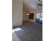 Spacious living room with new carpet, ceiling fan, and sliding door to the back patio at 9312 Yucca Blossom Dr, Las Vegas, NV 89134