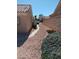 Side yard featuring low-maintenance desert landscaping, rock features, and desert pathway at 9312 Yucca Blossom Dr, Las Vegas, NV 89134