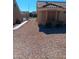 Side yard featuring low-maintenance desert landscaping, rock features, and desert pathway at 9312 Yucca Blossom Dr, Las Vegas, NV 89134