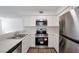 Updated kitchen with stainless steel appliances, white cabinets, and durable countertops at 9325 W Desert Inn Rd # 120, Las Vegas, NV 89117