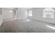 Bright living room with neutral carpet, large windows, and a sliding door leading to the patio at 9325 W Desert Inn Rd # 120, Las Vegas, NV 89117