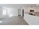 Open-concept living area with a view of the modern kitchen and plenty of natural light at 9325 W Desert Inn Rd # 120, Las Vegas, NV 89117