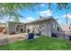 Charming backyard with well-kept lawn, patio area, and lush tree providing ample shade at 942 Westminster Ave, Las Vegas, NV 89119