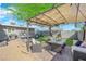 Backyard patio area with outdoor furniture, lush lawn, and a shaded pergola, perfect for relaxing at 942 Westminster Ave, Las Vegas, NV 89119